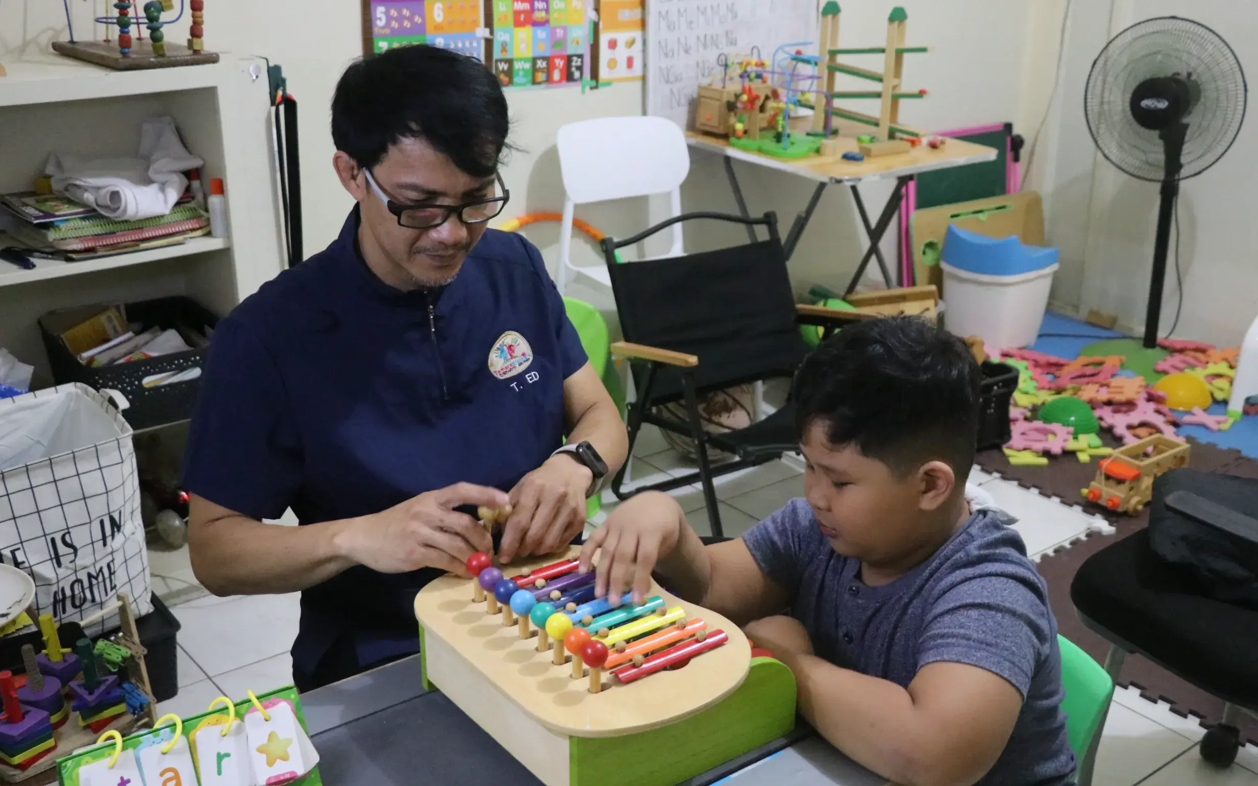 Filipino pediatric therapist with a happy child during a supportive session in Naga City