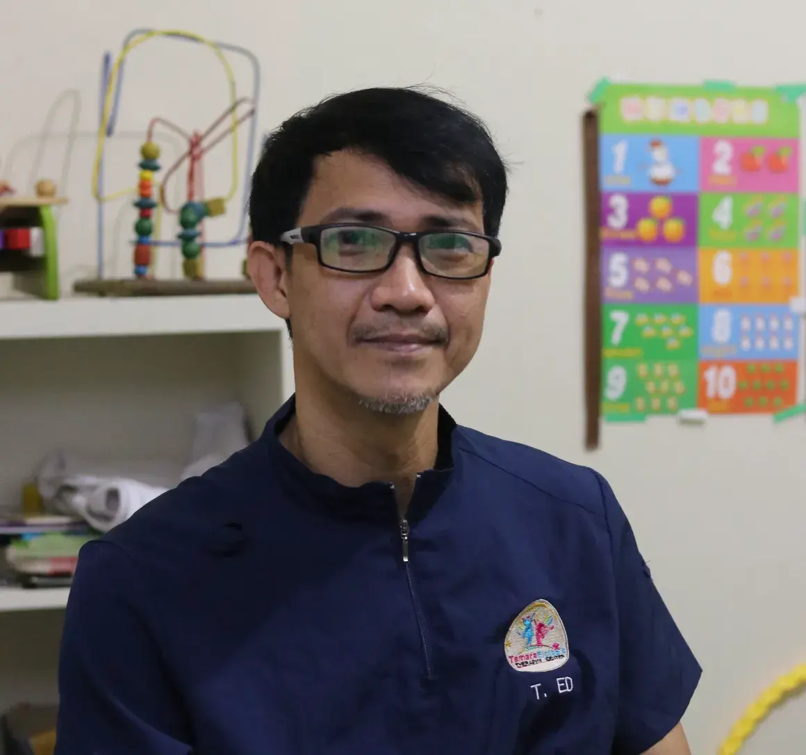 Teacher Ed, head therapist, working with a child at the center