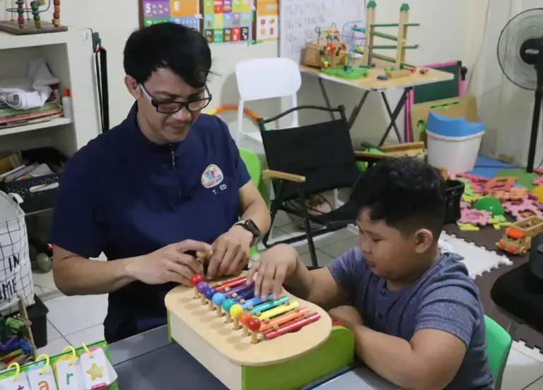 Filipino pediatric therapist with a happy child during a supportive session in Naga City